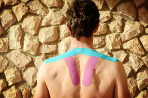 Man With Kinesiology Tape On Back